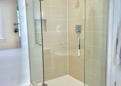Image of tan shower with frameless neo angle from Shower Door King.