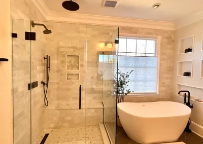 Image of tan shower area with contemporary frameless panel door panel and return from Shower Door King.