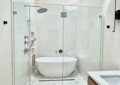 Image of white shower with low iron panel door panel from Shower Door King.
