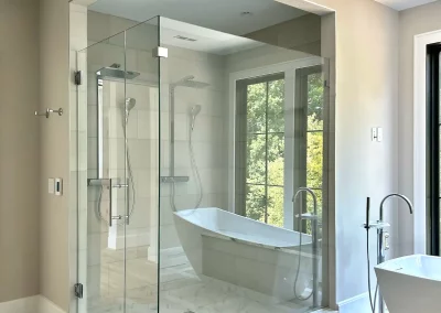 Image of tan and white shower area with door panel and return from Shower Door King.